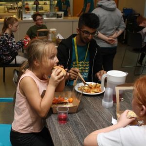 Young people enjoying hot meal at Holiday Club