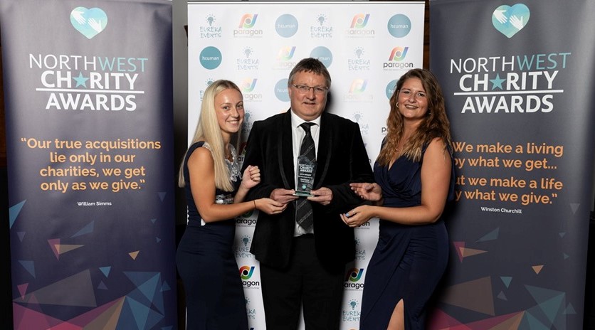 Manchester Youth Zone CEO, Richard March, and staff Lucy and Kirsty receiving the Charity of the Year trophy at North West Charity Awards 2019